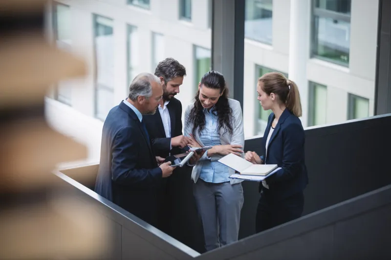 Attorneys reviewing documents together in a bright office