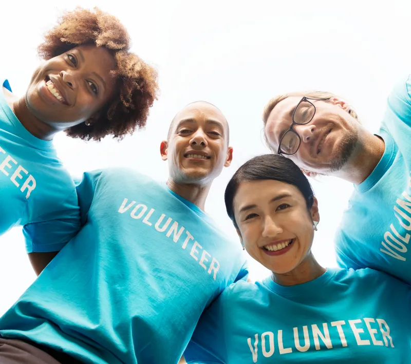 Smiling volunteers in matching blue volunteer shirts